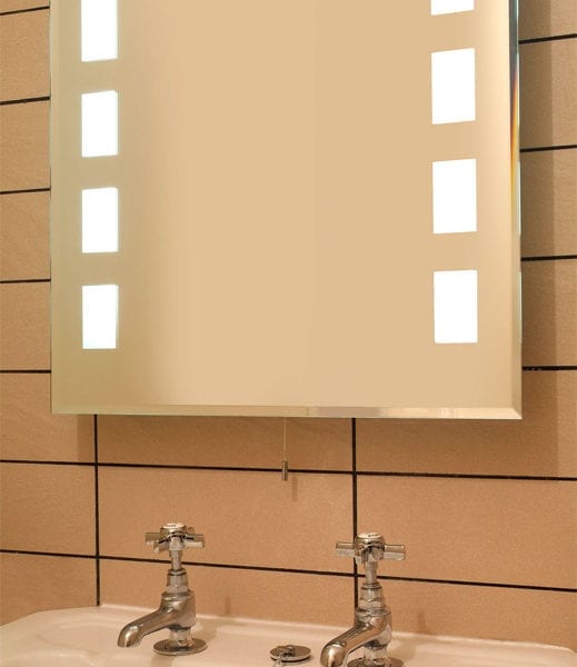 a tiled bathroom with a mirror