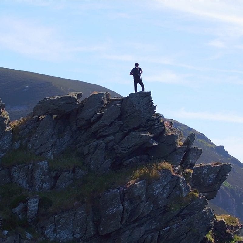 a man standing on a rocky cliff
