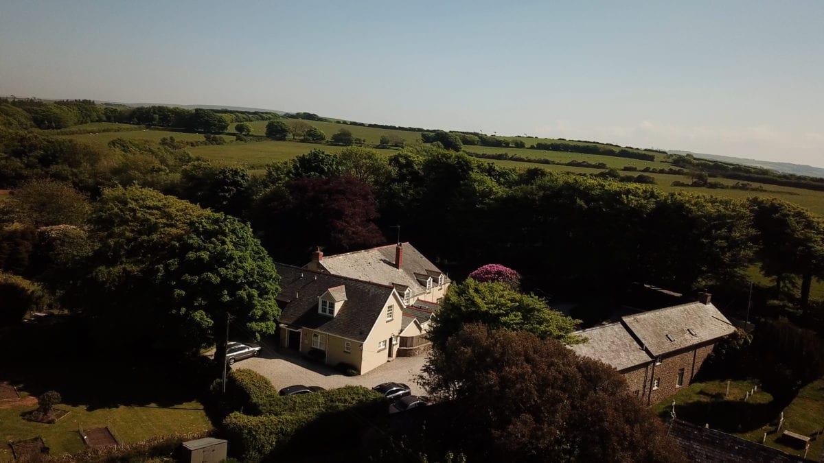 a picture of an aerial view of cream and brick buildings with surrounding trees