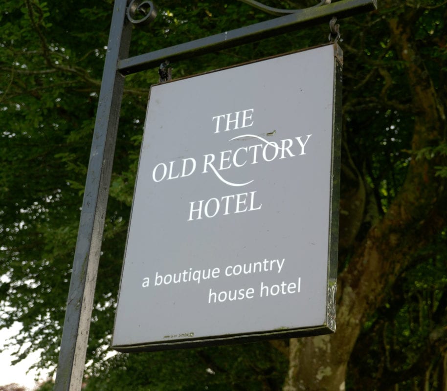 a picture of the old rectory hotel sign outside